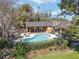 Community pool with shaded seating and a gazebo in a lush setting at 1621 Ne 2Nd St # 601, Ocala, FL 34470