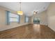 Bright and airy living room with hardwood floors and sliding glass doors to a screened patio at 1903 Nw 50Th Cir, Ocala, FL 34482