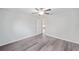 Bedroom with gray wood floors, a ceiling fan, and a view to the house interior at 22 Juniper Drive Crse, Ocala, FL 34480