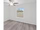 Bedroom with a ceiling fan, window view, and modern flooring at 22 Juniper Drive Crse, Ocala, FL 34480