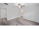 Bedroom featuring ceiling fan, grey wood floors and a view to an attached bathroom at 22 Juniper Drive Crse, Ocala, FL 34480