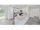 Bright kitchen featuring stainless steel appliances, granite countertops, grey wood floors and a view to the backyard at 22 Juniper Drive Crse, Ocala, FL 34480