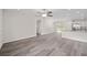 Open concept living room with gray wood-look floors and a kitchen with white cabinets at 22 Juniper Drive Crse, Ocala, FL 34480