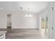 Bright and airy living room with modern chandelier and sliding door access to the backyard at 22 Juniper Drive Crse, Ocala, FL 34480
