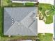 An aerial view of a well-maintained house with a clean roof, manicured lawn, and established landscaping at 383 Harlow Ln, The Villages, FL 32163
