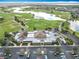 Golf club restaurant with parking and dining areas amid scenic golf course and lake views at 383 Harlow Ln, The Villages, FL 32163