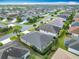 Residential aerial view of neighborhood streets, showcasing roofs and lush greenery at 383 Harlow Ln, The Villages, FL 32163