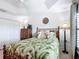 Bright bedroom with tropical bedding, closet, and bamboo-style furniture at 383 Harlow Ln, The Villages, FL 32163