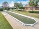 Outdoor Bocce Ball court surrounded by green spaces and palm trees at 383 Harlow Ln, The Villages, FL 32163