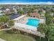 Aerial view of a community pool with lounge chairs and tables at 383 Harlow Ln, The Villages, FL 32163