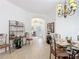 Open-concept dining area leading to the foyer with tile floors and stylish furnishings at 383 Harlow Ln, The Villages, FL 32163