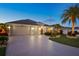 Spacious three car garage with long driveway and beautifully landscaped front yard at 383 Harlow Ln, The Villages, FL 32163