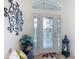 Bright entryway featuring a decorative glass door, side panels, transom window, and a decorative lantern at 383 Harlow Ln, The Villages, FL 32163
