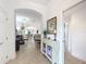 Elegant foyer featuring a decorative console table and arched doorways leading to the dining and living areas at 383 Harlow Ln, The Villages, FL 32163