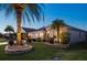 Well-manicured front yard with a brick paver retaining wall and beautiful landscaping at 383 Harlow Ln, The Villages, FL 32163