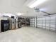 Spacious garage includes refrigerator, work bench, and storage at 383 Harlow Ln, The Villages, FL 32163