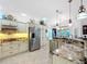 Modern kitchen featuring granite countertops, stainless steel appliances, and cream colored cabinetry at 383 Harlow Ln, The Villages, FL 32163