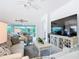 Inviting living room with modern furnishings, a large flat-screen TV, and views of the lanai at 383 Harlow Ln, The Villages, FL 32163