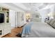 Spacious main bedroom with hardwood floors, tray ceilings, and a view of an open doorway at 383 Harlow Ln, The Villages, FL 32163