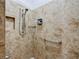 Shower features tan tiling, a built-in shelf, a handrail, and a shower-head at 383 Harlow Ln, The Villages, FL 32163