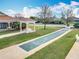 Outdoor shuffleboard court with adjacent gazebo, lawn, landscaping and seating at 383 Harlow Ln, The Villages, FL 32163