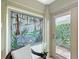 Sun Room with a chair and a stained glass window and a door to the outside at 383 Harlow Ln, The Villages, FL 32163