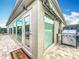 Enclosed sunroom featuring outdoor grill, brick floors, and retractable awning providing additional outdoor living space at 383 Harlow Ln, The Villages, FL 32163