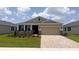 Charming single-story home featuring a two-car garage, manicured lawn, and lovely stone accents at 4008 Nw 48Th Terrace Rd, Ocala, FL 34482