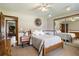 Bedroom featuring wood floors, soft lighting, and mirrored closet at 4420 Ne 1St St, Ocala, FL 34470