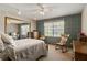Cozy bedroom with patterned wallpaper, rocking chair, and large window at 4420 Ne 1St St, Ocala, FL 34470