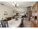 Open concept dining and living room with a brick fireplace and hardwood floors at 4420 Ne 1St St, Ocala, FL 34470