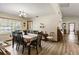 Bright dining room featuring hardwood floors, a large window, and classic chandelier at 4420 Ne 1St St, Ocala, FL 34470