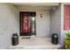 Charming entryway with red door, light grey brick and vintage décor at 4420 Ne 1St St, Ocala, FL 34470