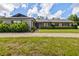 Inviting single-story home with red shutters, mature hedges, and well-manicured lawn at 4420 Ne 1St St, Ocala, FL 34470