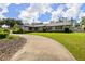 Well-maintained single-story home with red shutters, green grass, and a curved driveway at 4420 Ne 1St St, Ocala, FL 34470