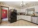 Functional kitchen featuring white cabinets, black appliances, and tiled flooring at 4420 Ne 1St St, Ocala, FL 34470