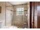 Bright bathroom features a tiled shower, glass door, and a convenient built-in seat at 4420 Ne 1St St, Ocala, FL 34470
