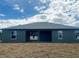 Exterior of home showcasing the backyard, patio area, and window placement at 4501 Sw 110Th Ln, Ocala, FL 34476