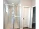 Modern bathroom features glass-enclosed shower with tile surround, enhancing a bright and clean aesthetic at 4501 Sw 110Th Ln, Ocala, FL 34476