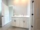 Bathroom with double sink vanity, white cabinets, and modern hardware at 4501 Sw 110Th Ln, Ocala, FL 34476