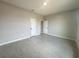 Bedroom with light-colored wood-look tile flooring, neutral walls, and white trim at 4501 Sw 110Th Ln, Ocala, FL 34476