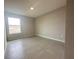 Spacious bedroom with wood-look tile floors and a bright window at 4501 Sw 110Th Ln, Ocala, FL 34476