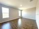 Bright bedroom offers ample natural light from two windows, showcasing the neutral walls and flooring at 4501 Sw 110Th Ln, Ocala, FL 34476