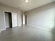 Bedroom with wood-look tile flooring, neutral walls, and a closet with sliding doors at 4501 Sw 110Th Ln, Ocala, FL 34476