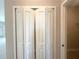 A hall closet with folding doors reveals shelving inside at 4501 Sw 110Th Ln, Ocala, FL 34476