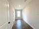 Hallway with natural light, showcasing the neutral walls and floors, connecting different areas of the home at 4501 Sw 110Th Ln, Ocala, FL 34476