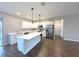 Bright kitchen featuring white cabinetry, a large island, and stainless steel appliances at 4501 Sw 110Th Ln, Ocala, FL 34476