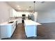 Modern kitchen boasts white cabinets, stainless appliances, and large center island with stone countertops at 4501 Sw 110Th Ln, Ocala, FL 34476