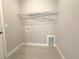 Laundry room with tile floors, washer and dryer hookups, and white wire shelf at 4501 Sw 110Th Ln, Ocala, FL 34476