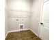 Small laundry room features wood-look tile floor and storage shelf, ready for washer/dryer hookups at 4501 Sw 110Th Ln, Ocala, FL 34476